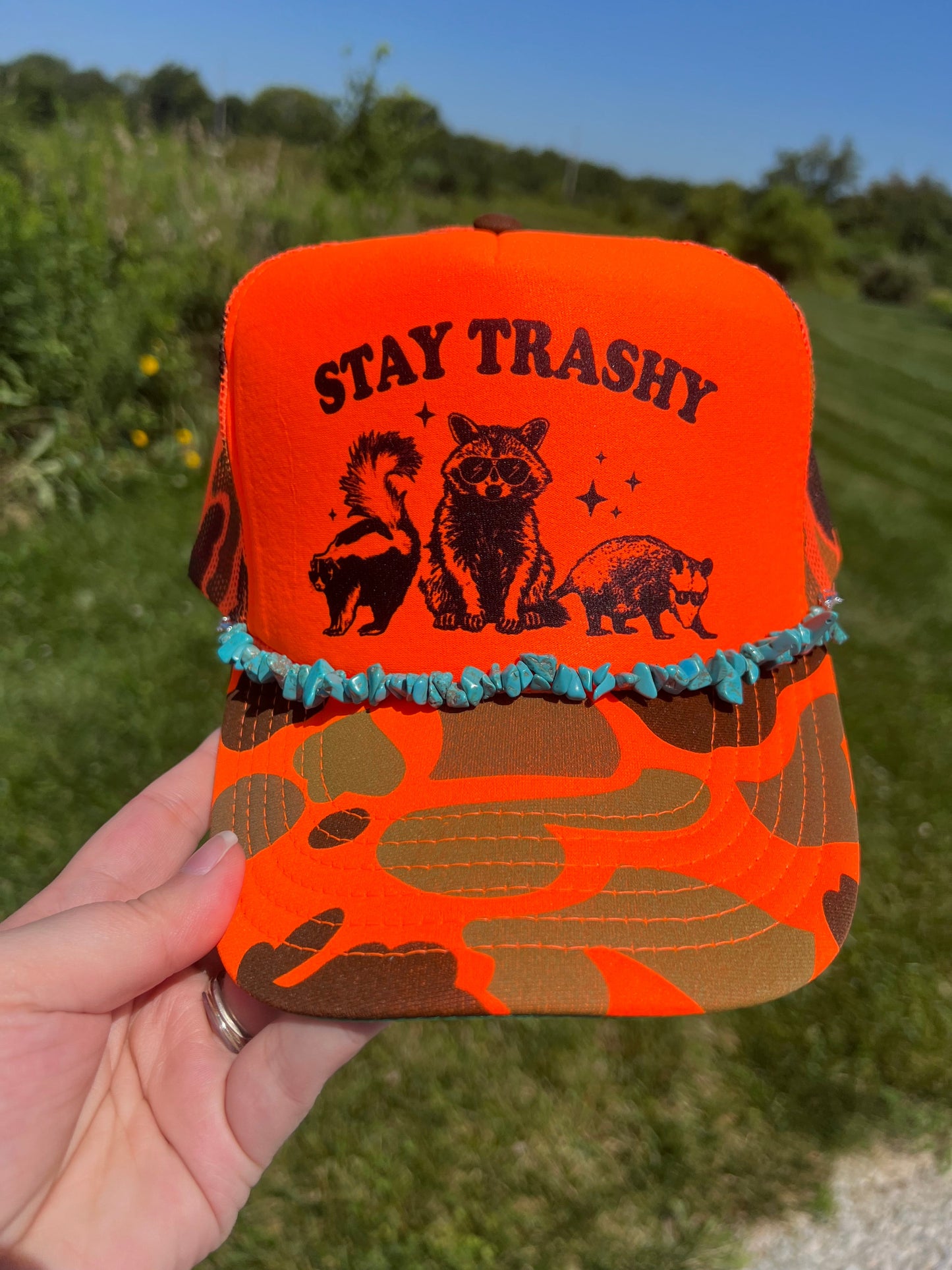 Stay trashy orange camo trucker hat